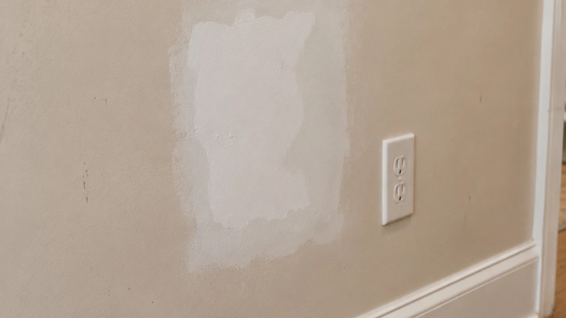 Drywall patch before repair and repainting by Roly Home Services