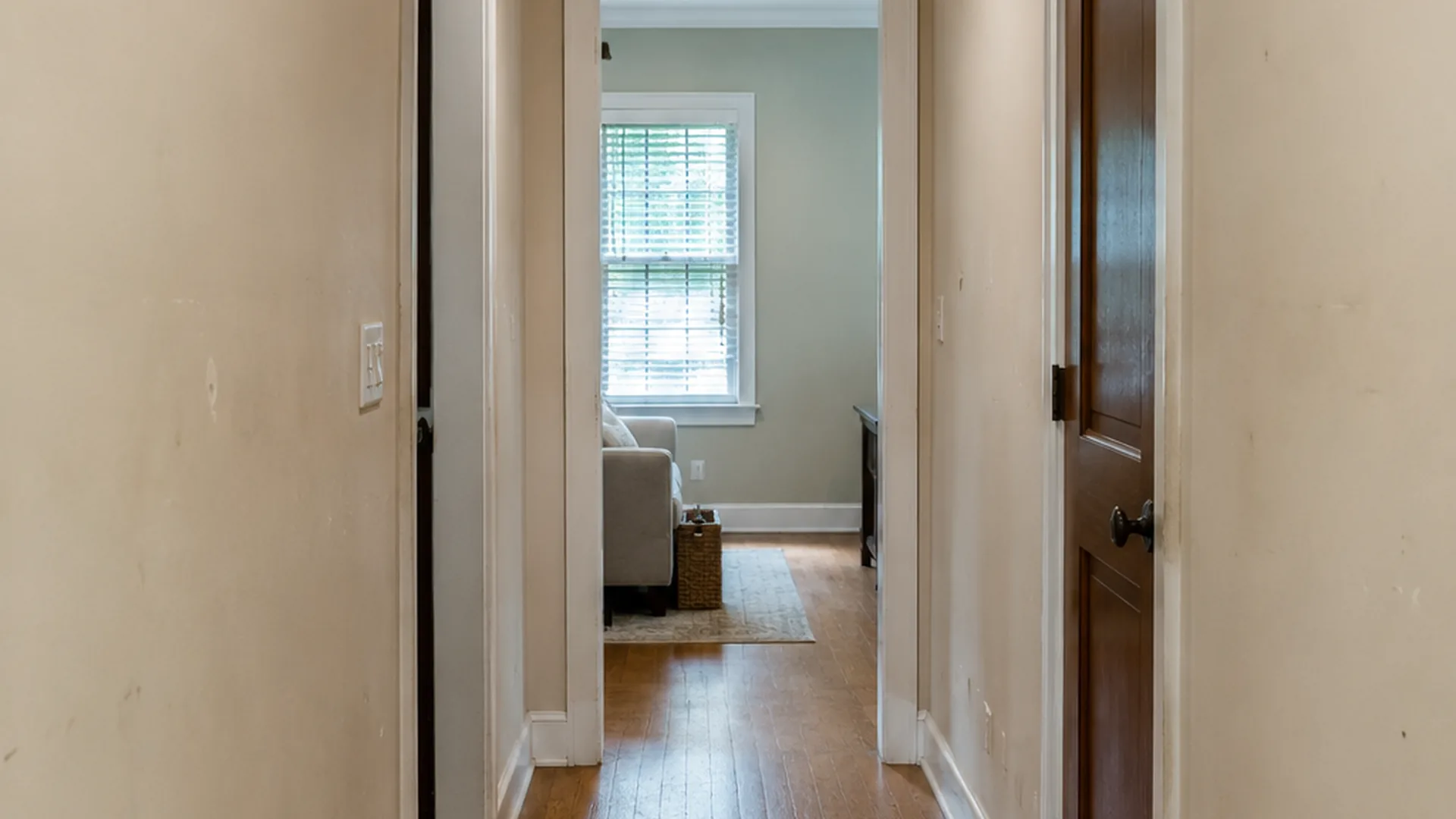 Interior hallway with scuffs before repainting by Roly Home Services